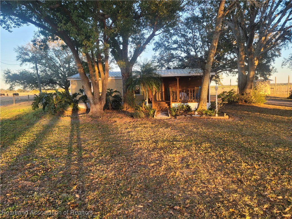 101 Bereah Road East Fort Meade, FL 33841 - Photo 2 of 7 a backyard of a house with lots of green space