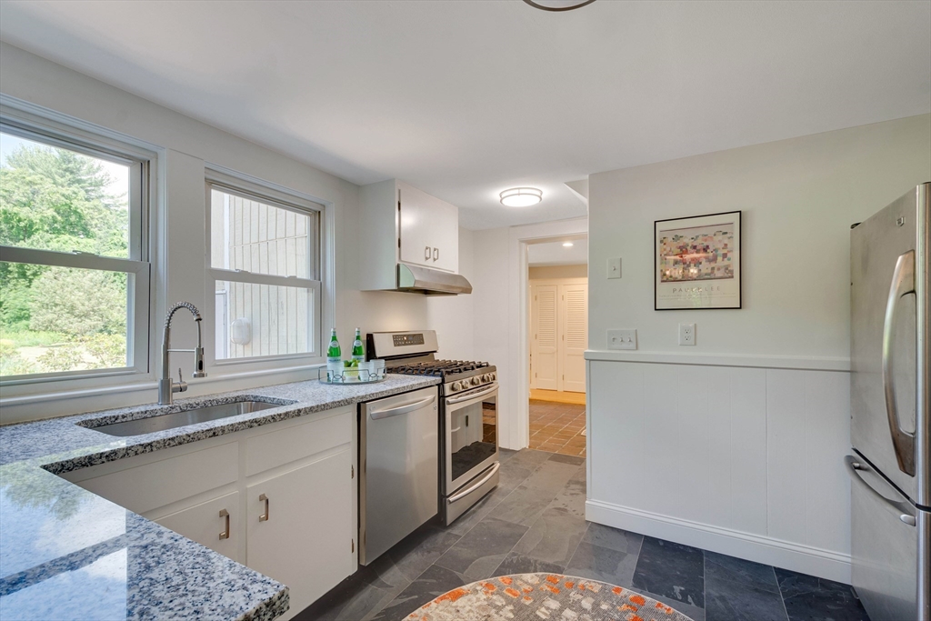 95 Tower Road Lincoln, MA 01773 - Photo 14 of 41 a kitchen with stainless steel appliances granite countertop a refrigerator sink and stove