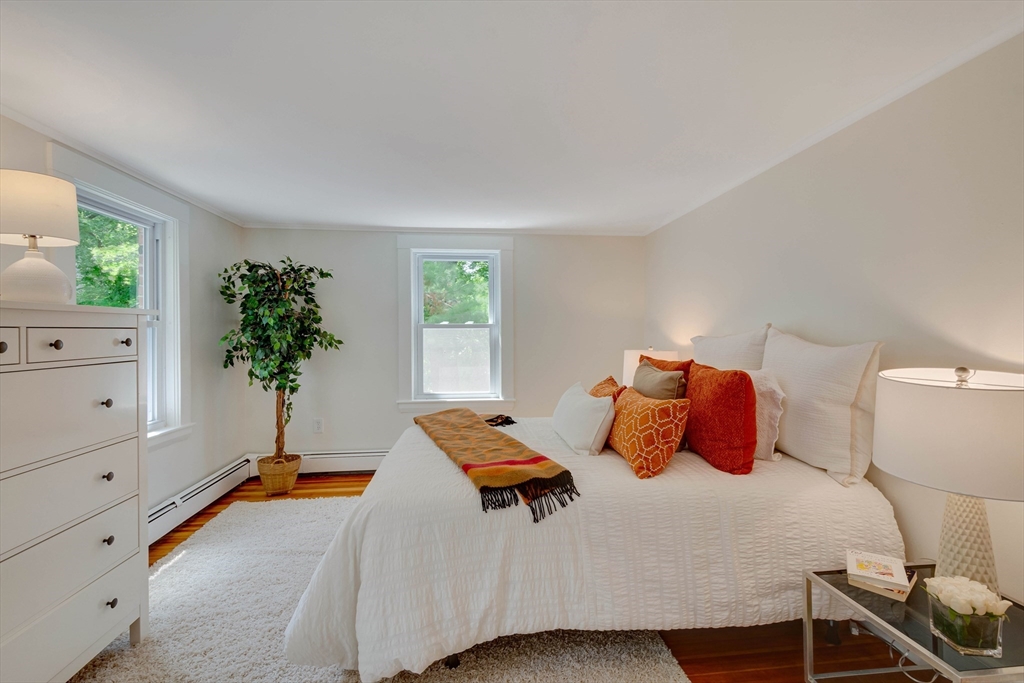 95 Tower Road Lincoln, MA 01773 - Photo 28 of 41 a bedroom with a bed and a potted plant