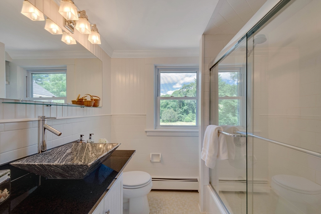 95 Tower Road Lincoln, MA 01773 - Photo 29 of 41 a bathroom with a sink a toilet and a mirror