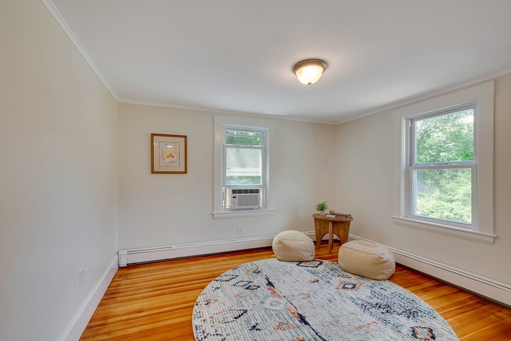 95 Tower Road Lincoln, MA 01773 - Photo 30 of 41 a bedroom with a bed and wooden floor