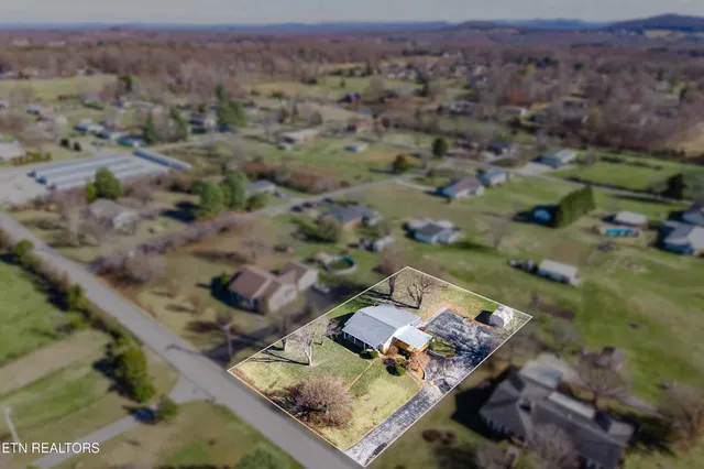 an aerial view of a house with a yard