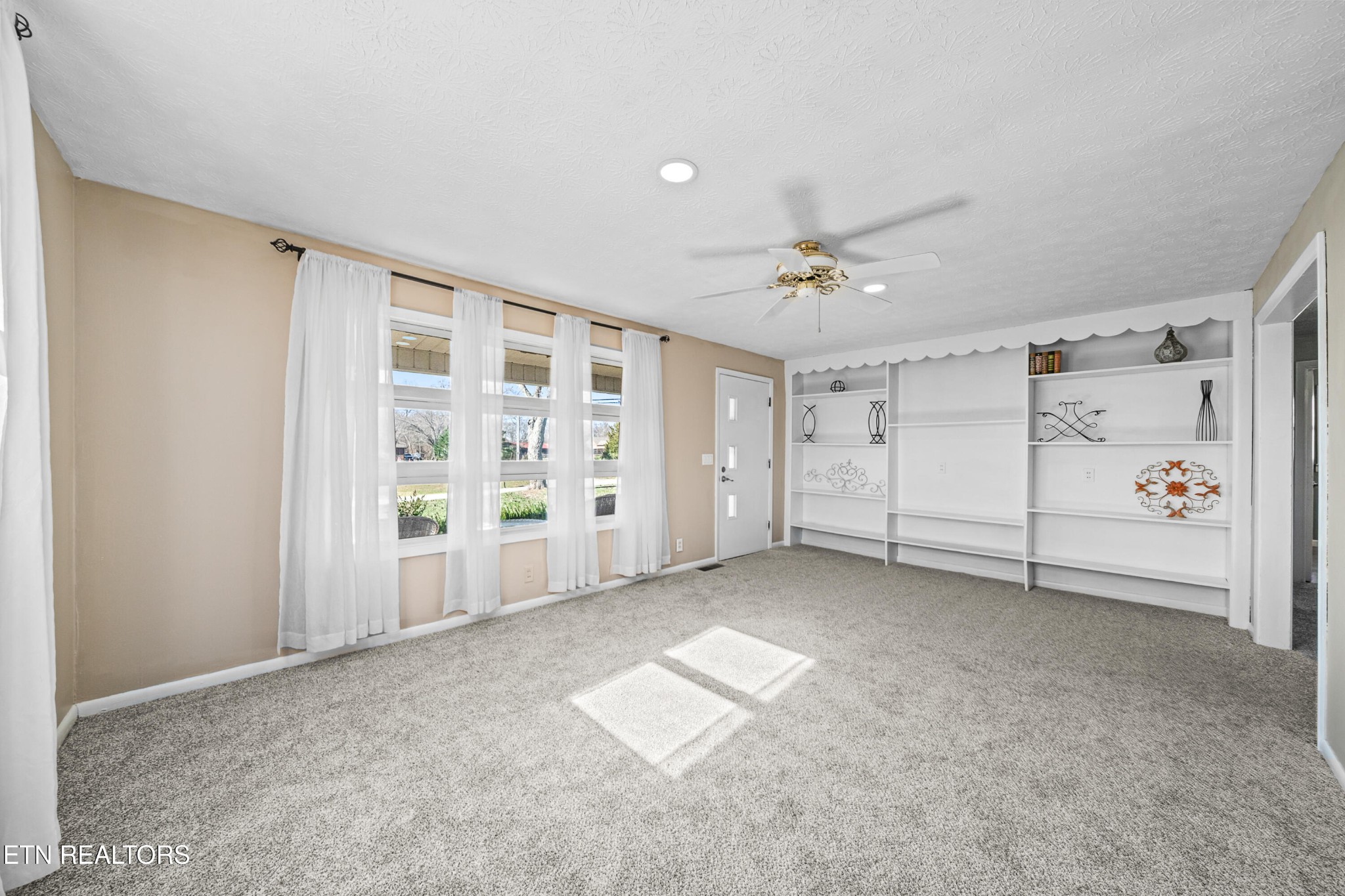 3323 Fisk Road Cookeville, TN 38506 - Photo 6 of 31 an empty room with windows and ceiling fan