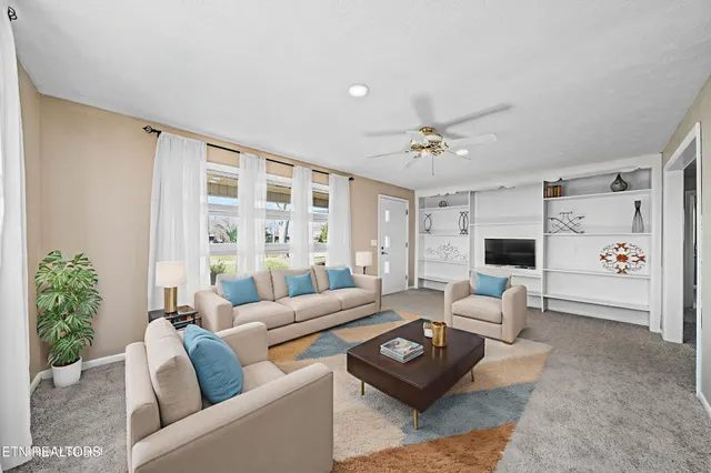 a living room with furniture and a large window