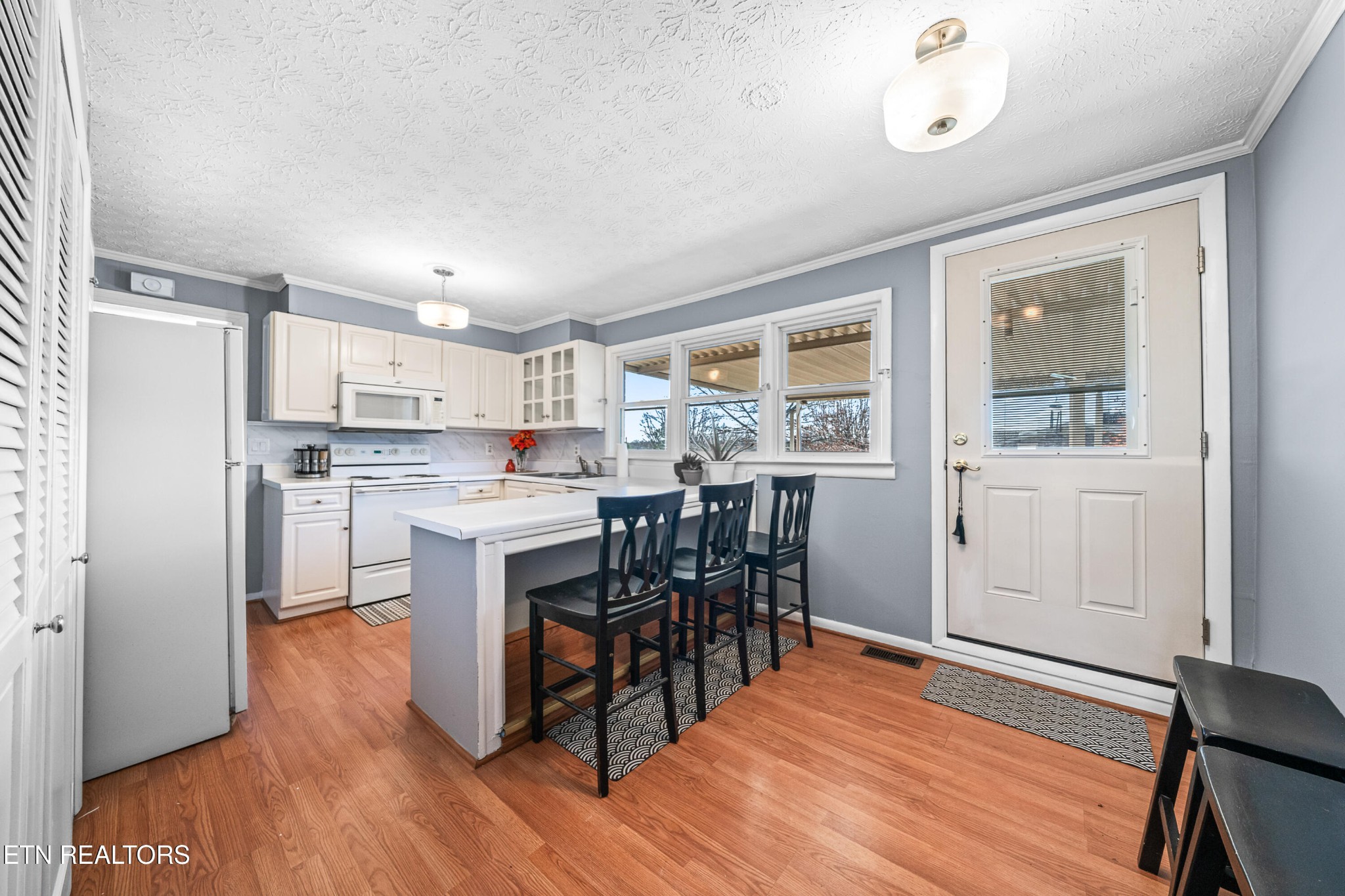 3323 Fisk Road Cookeville, TN 38506 - Photo 9 of 31 a kitchen with a table chairs refrigerator and cabinets