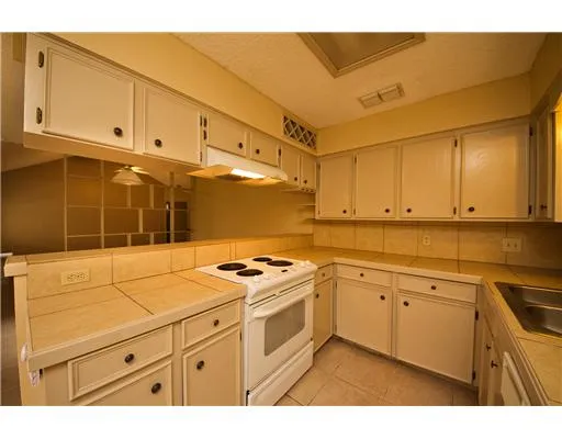 a kitchen with cabinets appliances and a sink