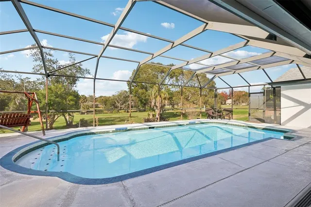 a view of a swimming pool with a yard