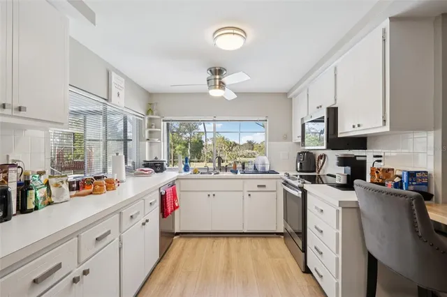 a kitchen with stainless steel appliances a sink stove and cabinets