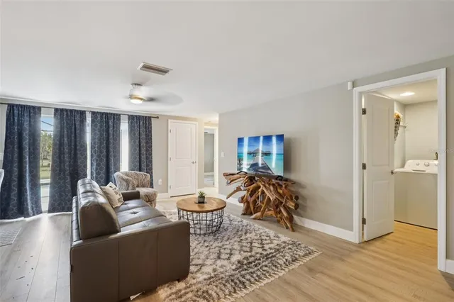 a living room with furniture and a wooden floor