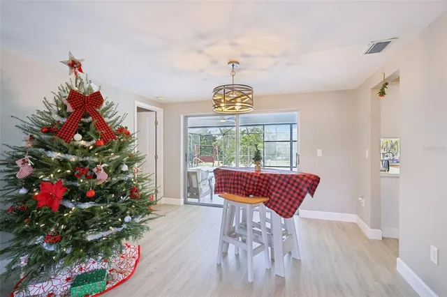 a living room with furniture a dining table and wooden floor