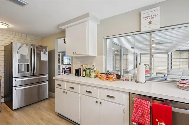 a kitchen with stainless steel appliances a refrigerator sink and cabinets