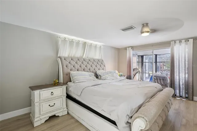 a bedroom with a large bed and a window