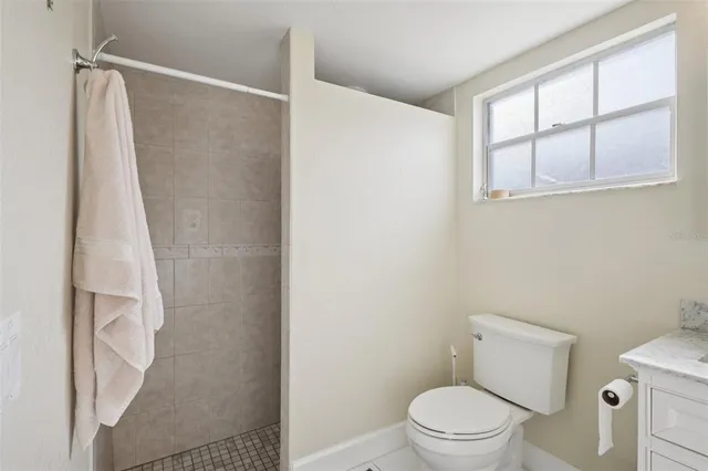 a white toilet sitting next to a shower curtain