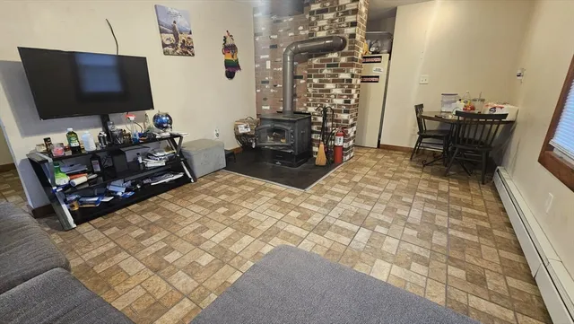 a room with furniture a flat screen tv and a fireplace