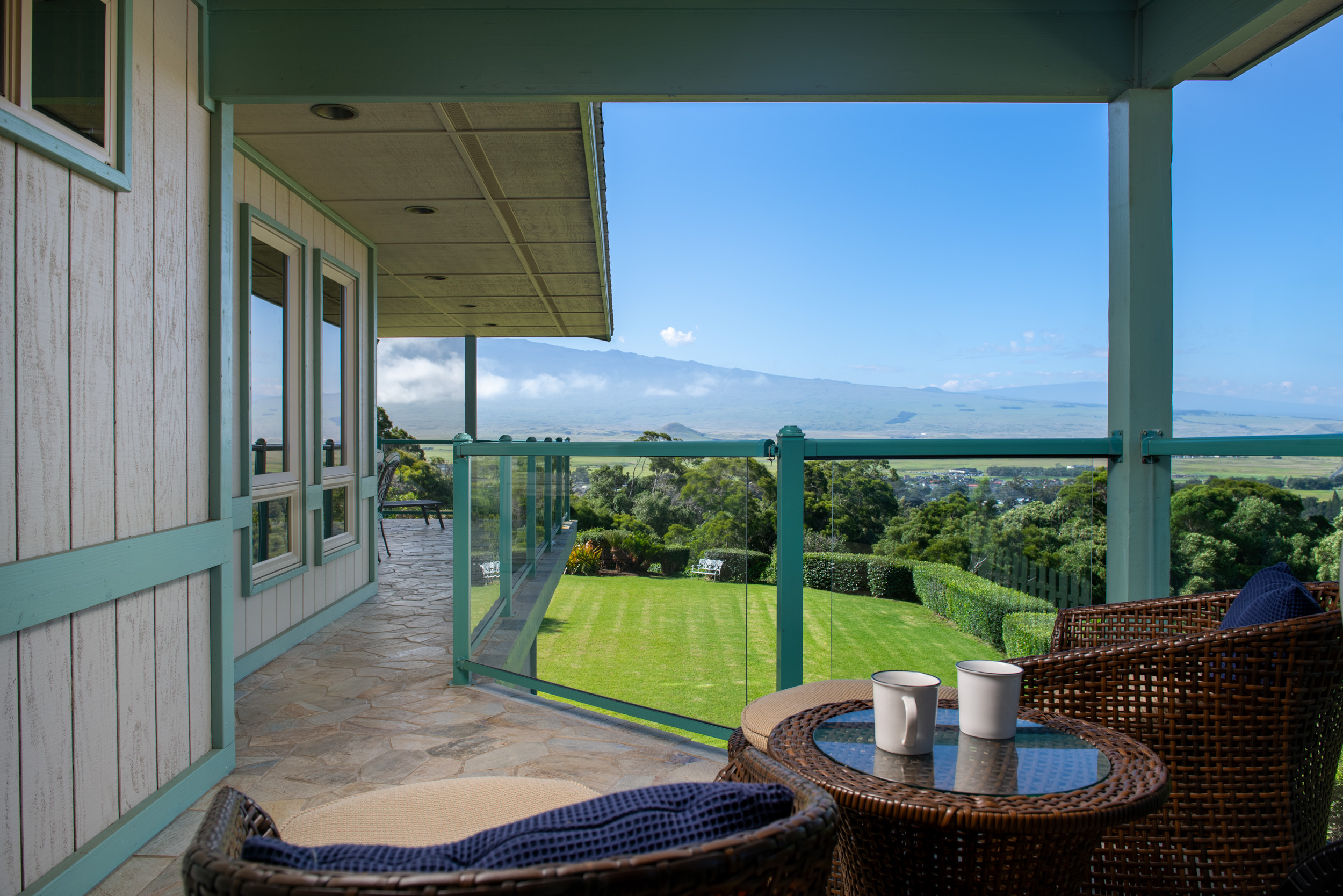 65-1310 Lihipali Road, Unit B Kamuela, HI 96743 - Photo 11 of 19 a view of a patio with a table chairs and a backyard