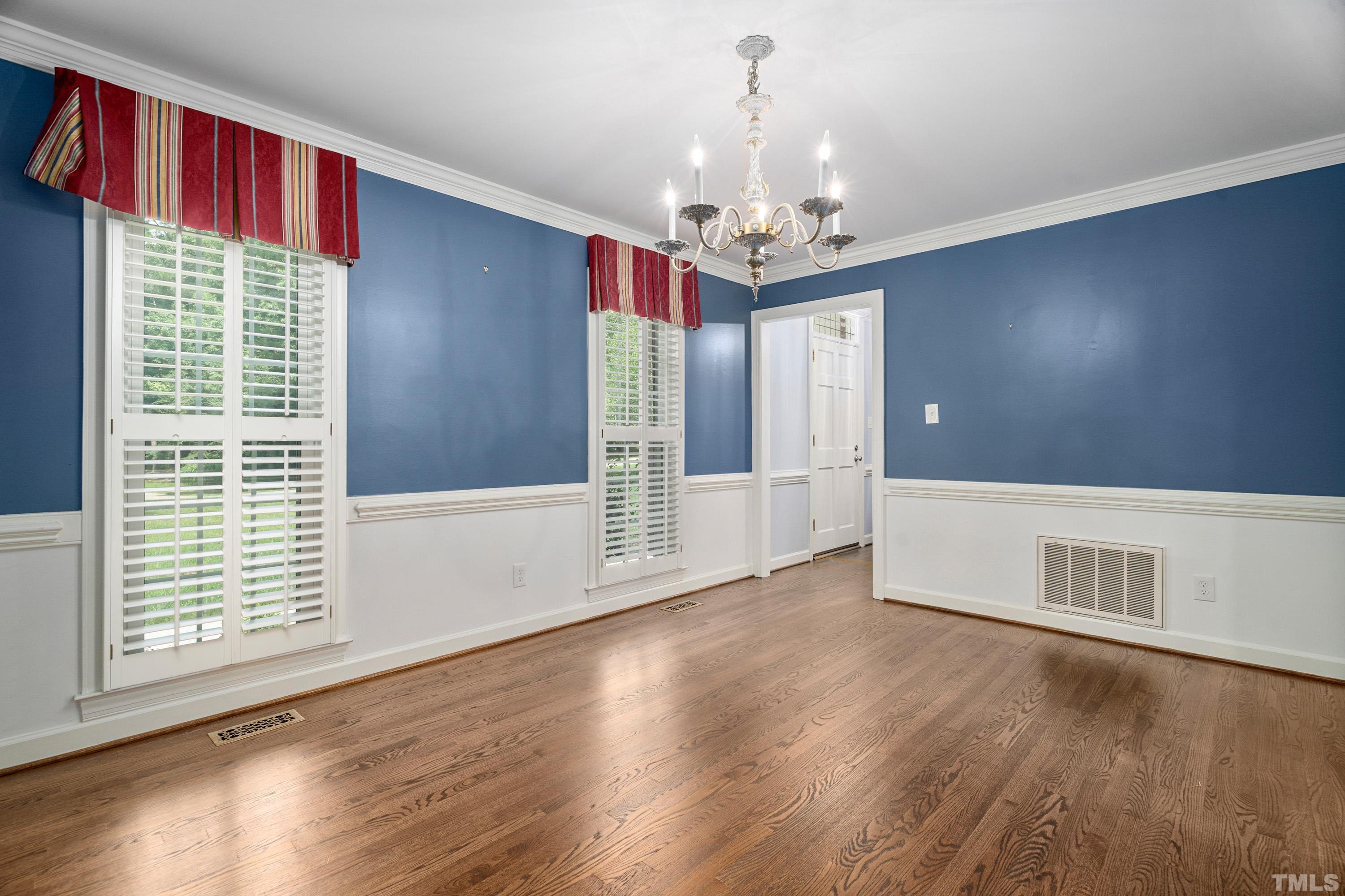 2013 Countrywood Road North Raleigh, NC 27615 - Photo 11 of 73 a view of a livingroom with wooden floor and a large window