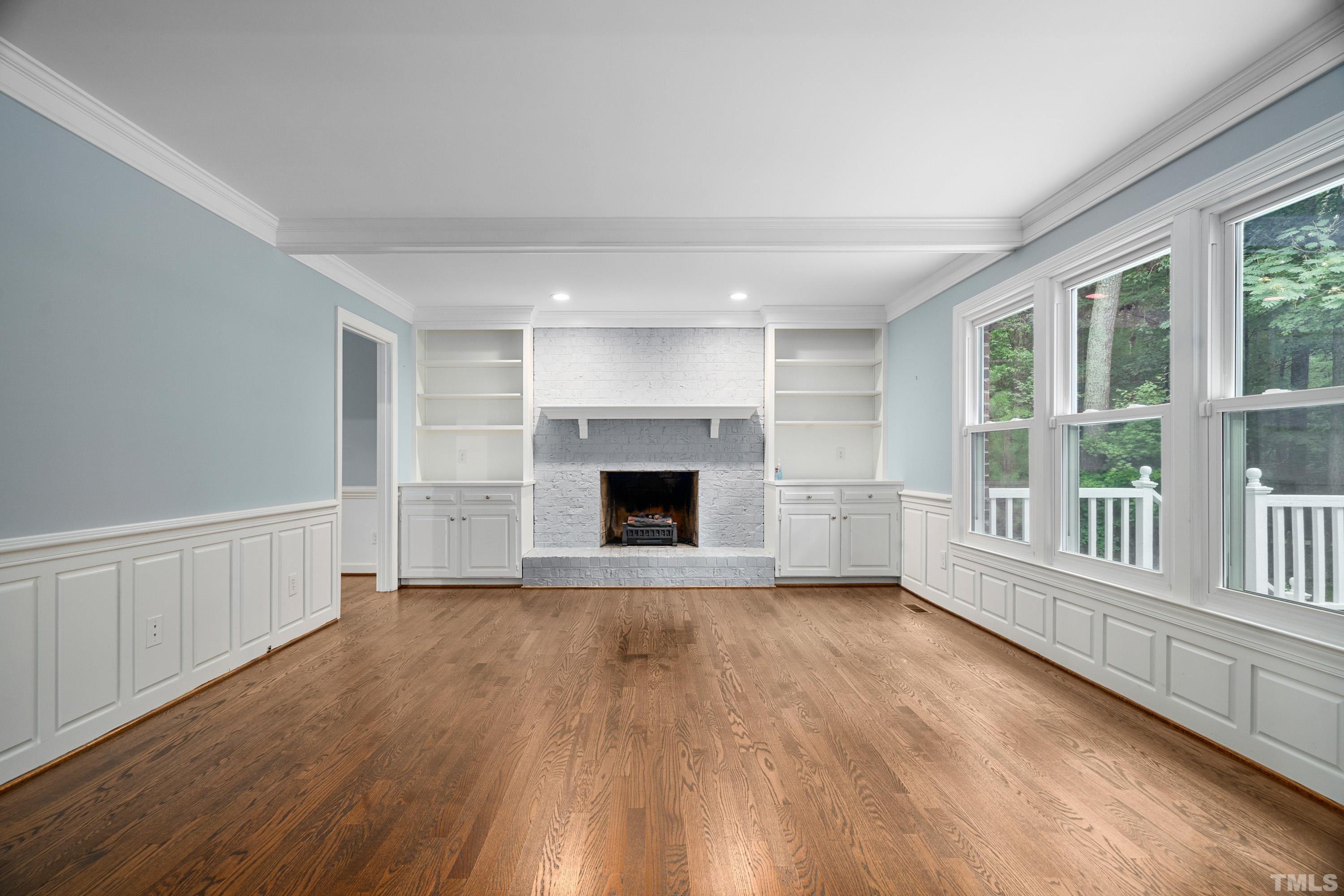 2013 Countrywood Road North Raleigh, NC 27615 - Photo 13 of 73 a view of an empty room with wooden floor and a window