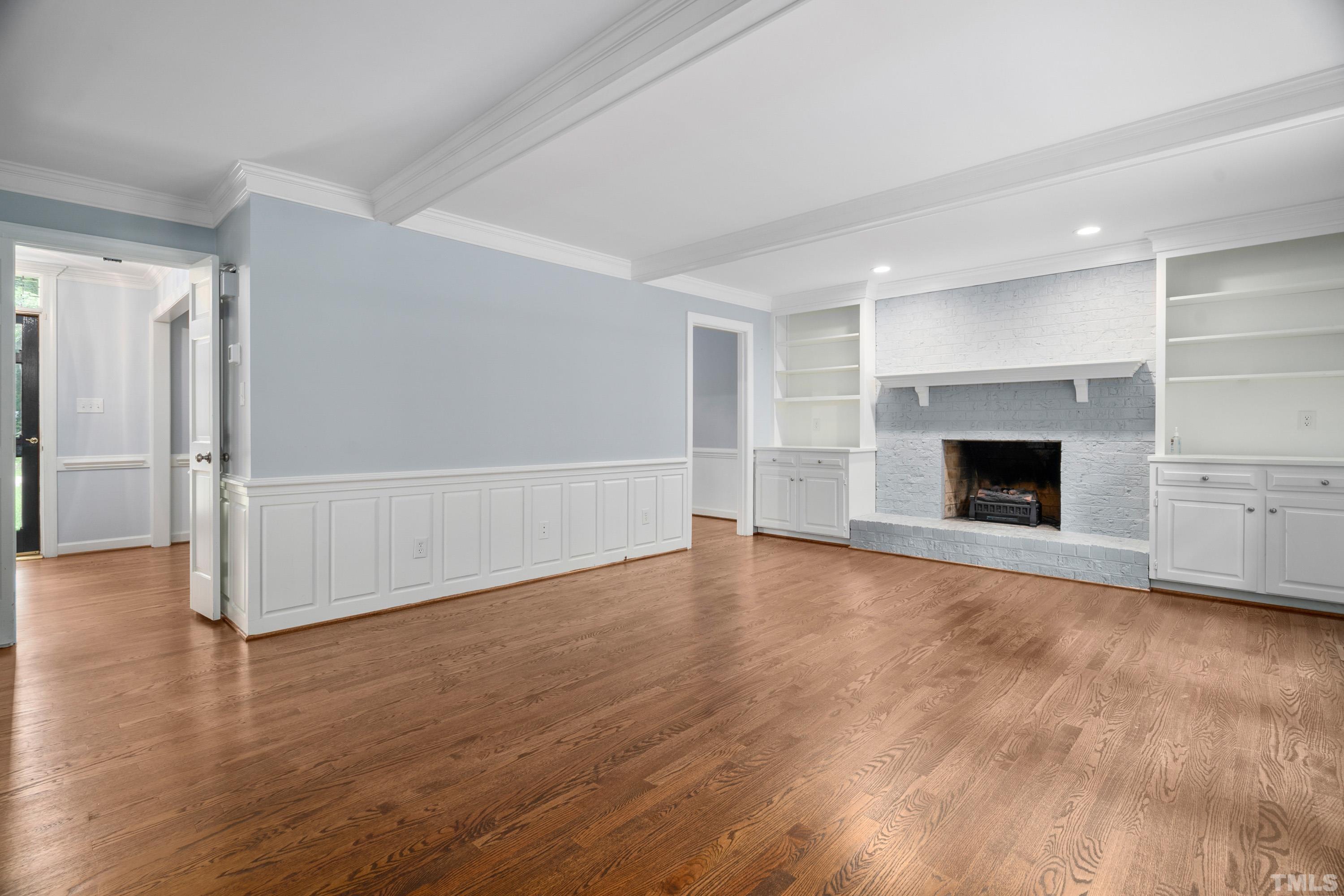 2013 Countrywood Road North Raleigh, NC 27615 - Photo 14 of 73 an empty room with wooden floor and fireplace