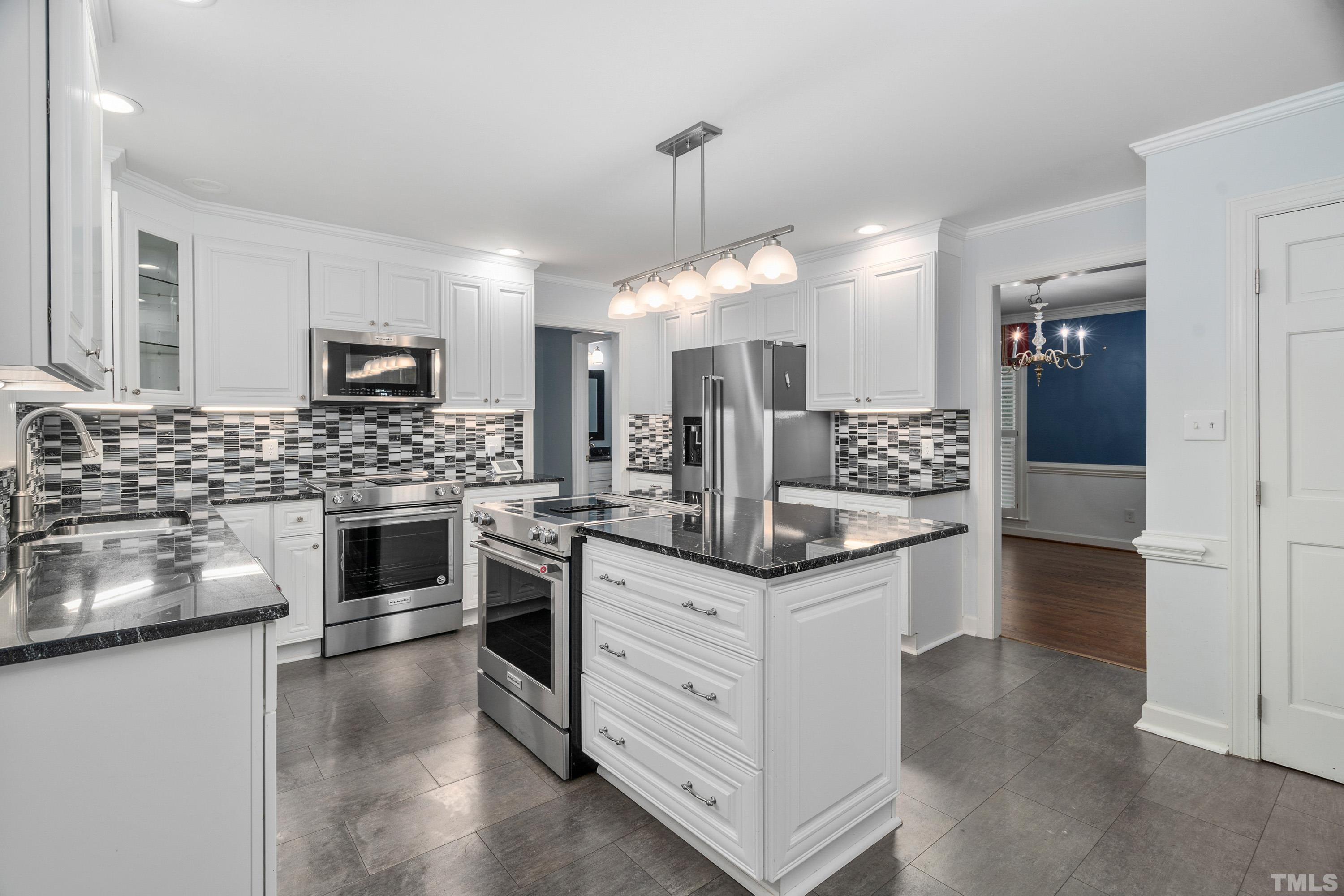 2013 Countrywood Road North Raleigh, NC 27615 - Photo 17 of 73 a kitchen with granite countertop white cabinets and stainless steel appliances