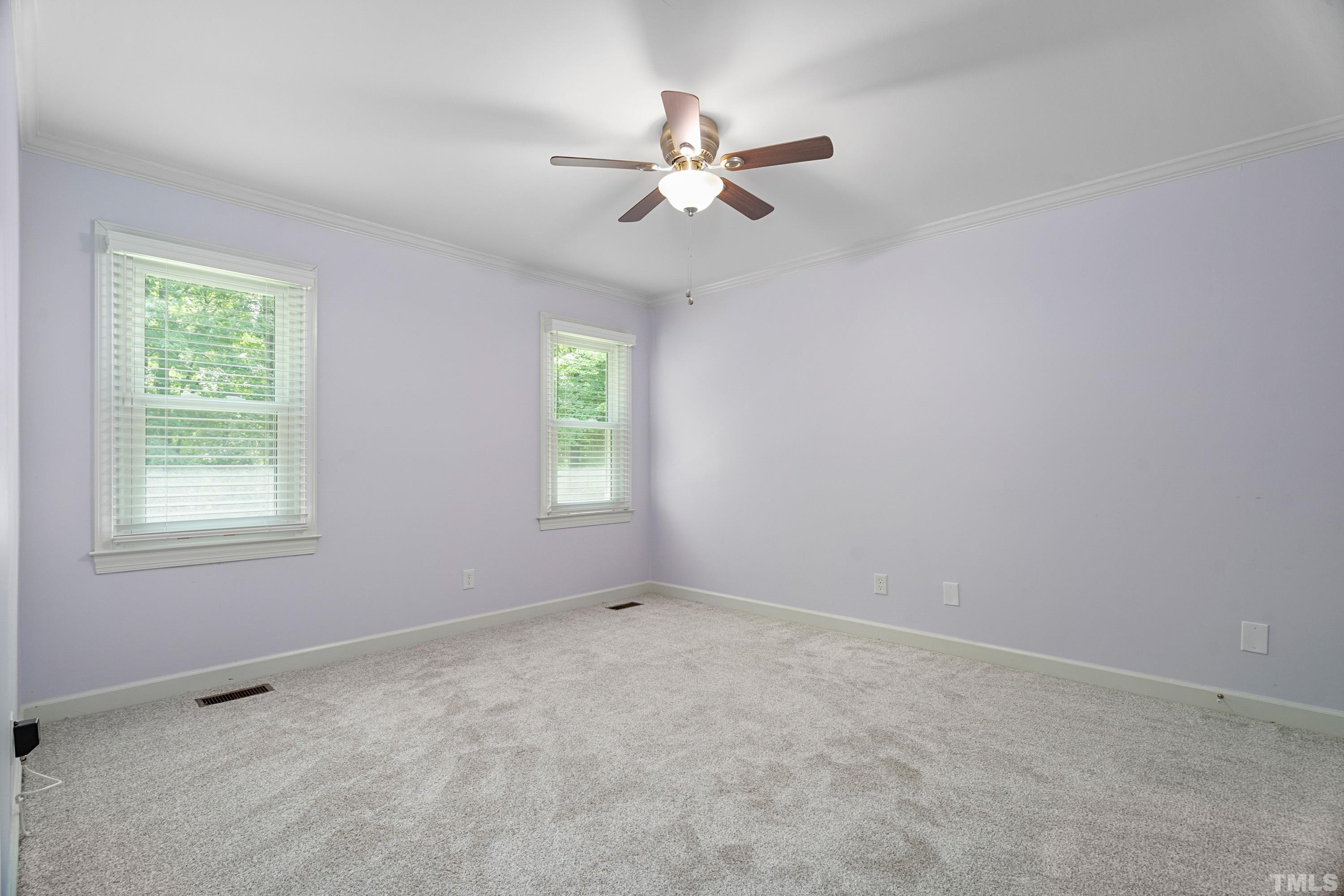 2013 Countrywood Road North Raleigh, NC 27615 - Photo 22 of 73 an empty room with a window and a fan
