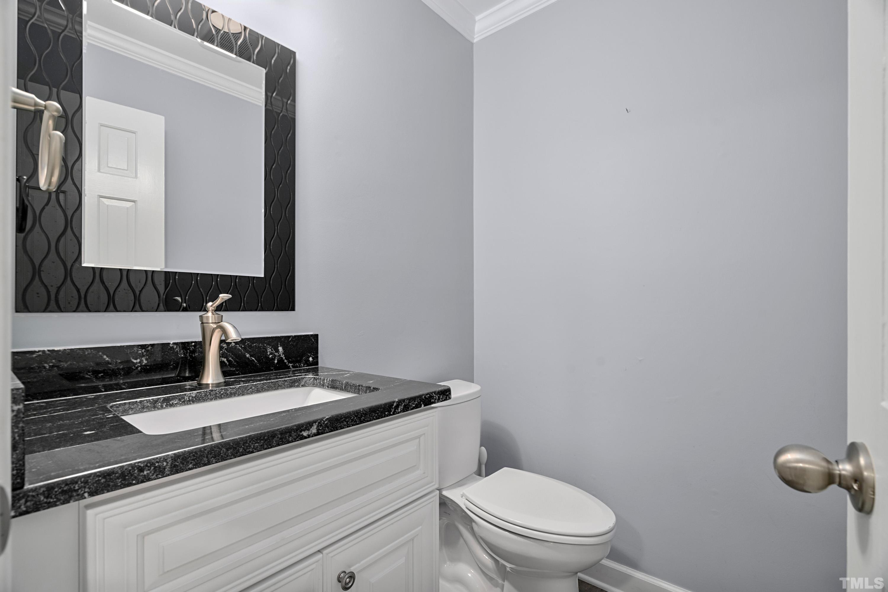 2013 Countrywood Road North Raleigh, NC 27615 - Photo 32 of 73 a bathroom with a toilet sink and mirror
