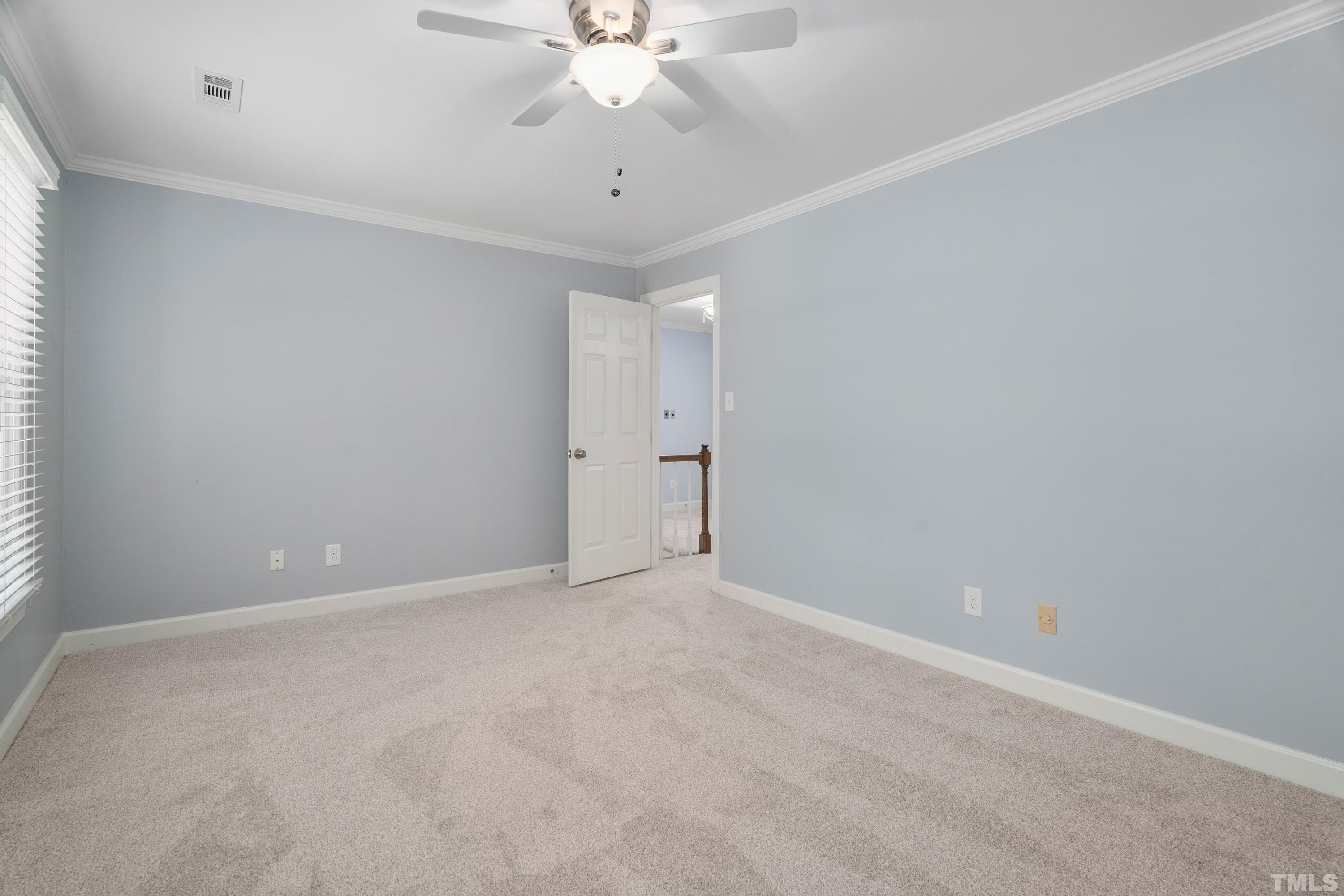 2013 Countrywood Road North Raleigh, NC 27615 - Photo 33 of 73 an empty room with a ceiling fan and a window