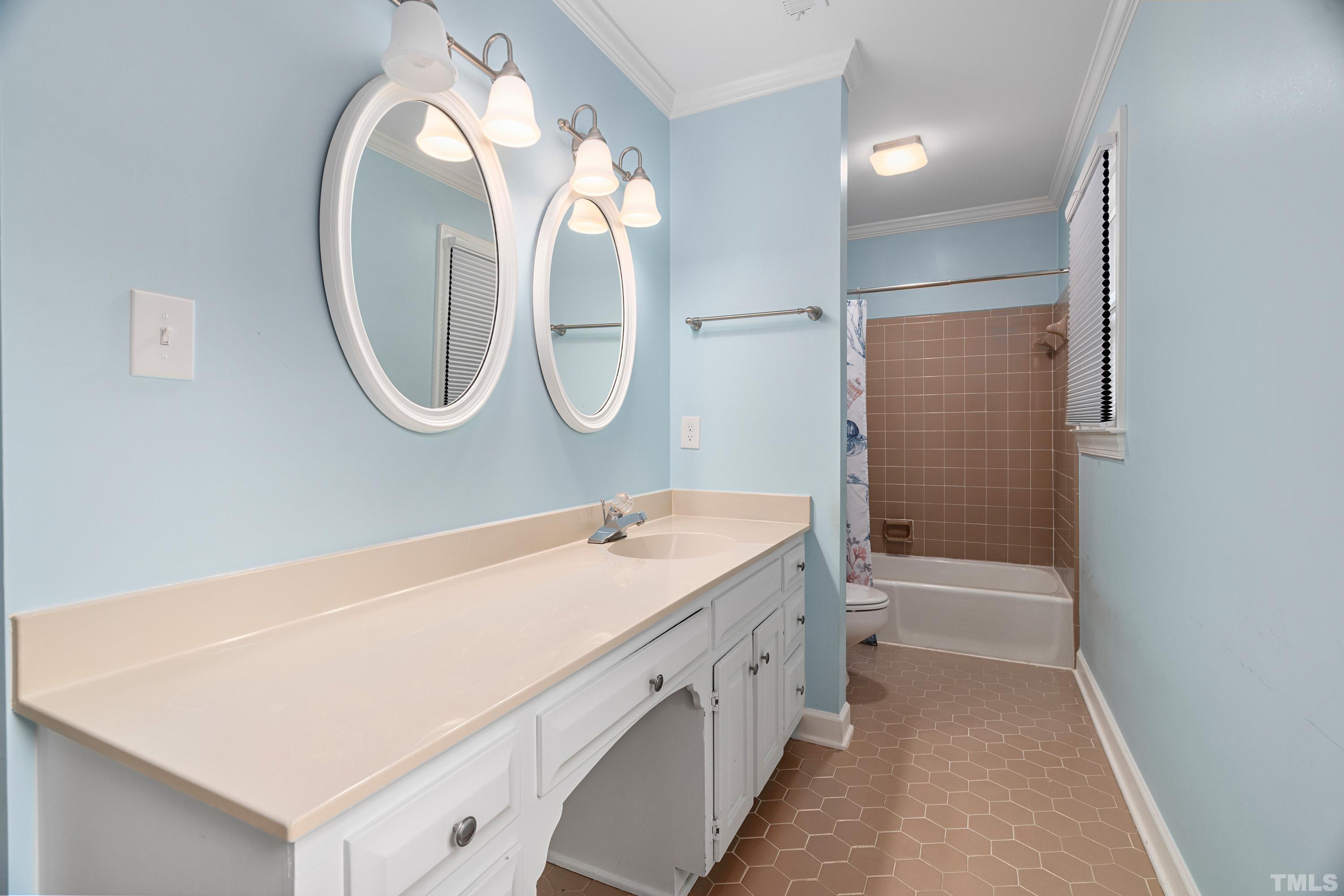 2013 Countrywood Road North Raleigh, NC 27615 - Photo 38 of 73 a bathroom with a tub a double vanity sink and a mirror