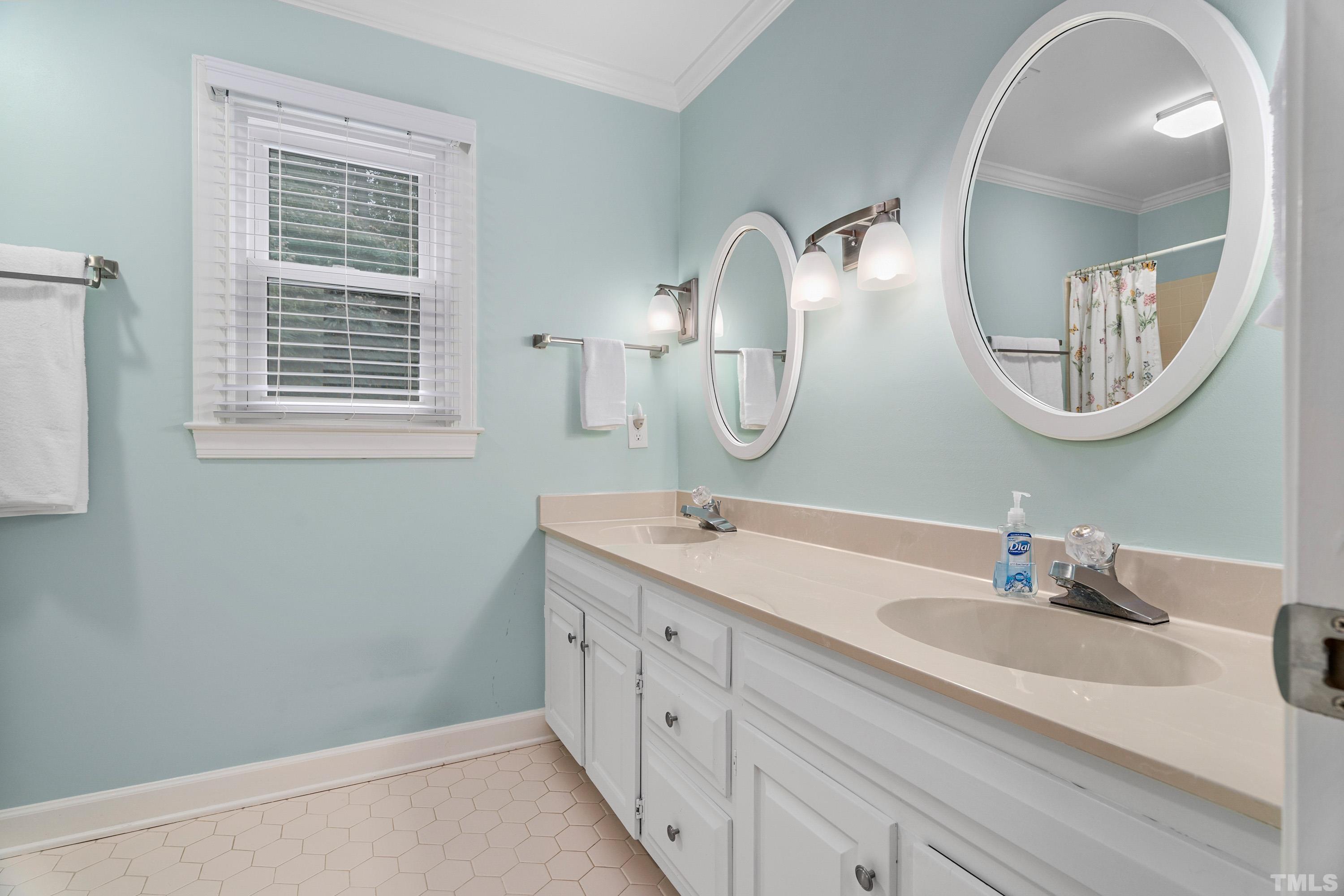 2013 Countrywood Road North Raleigh, NC 27615 - Photo 39 of 73 a en suite bathroom with a double vanity sink and a mirror