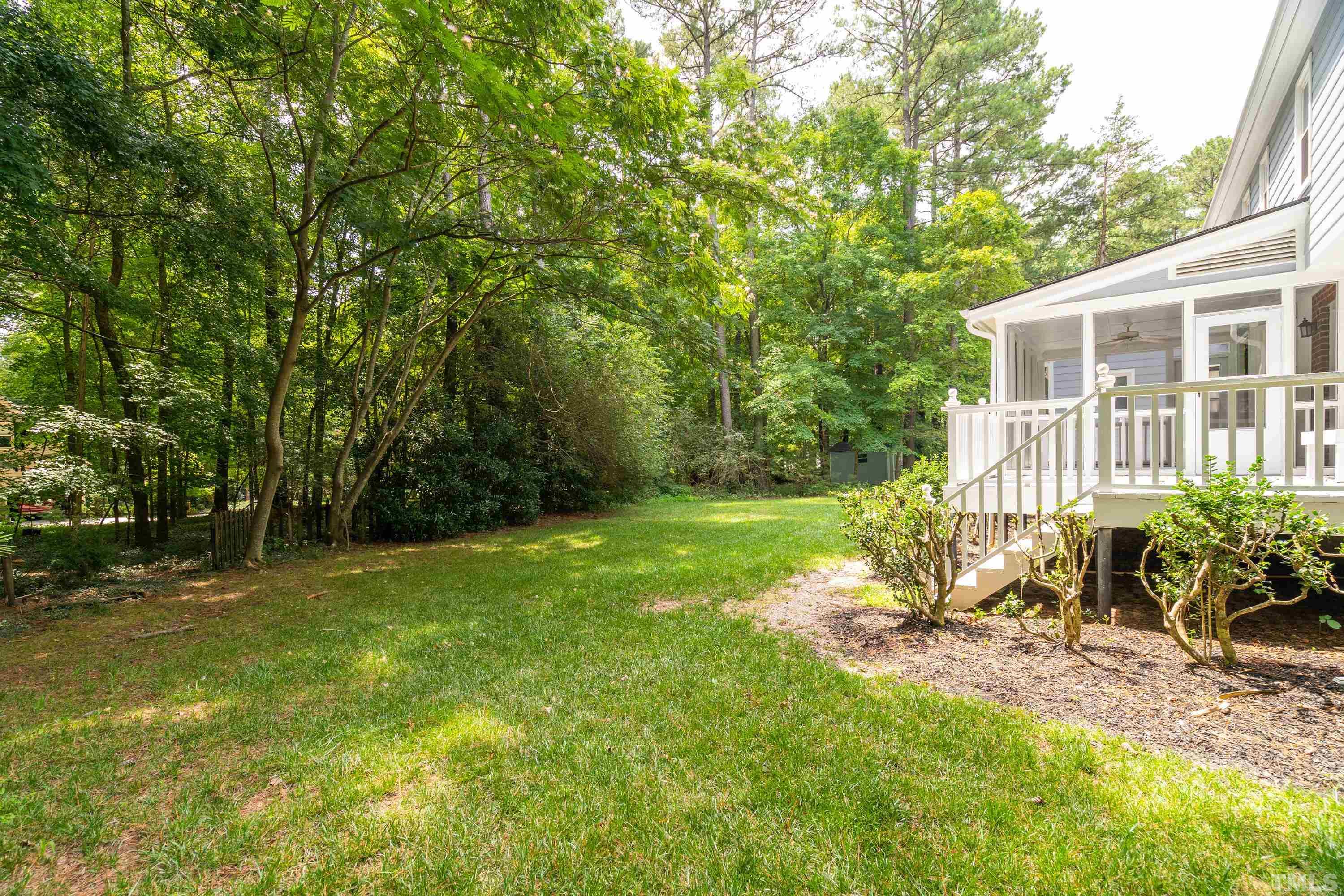 2013 Countrywood Road North Raleigh, NC 27615 - Photo 46 of 73 a view of a backyard with table and chairs and potted plants