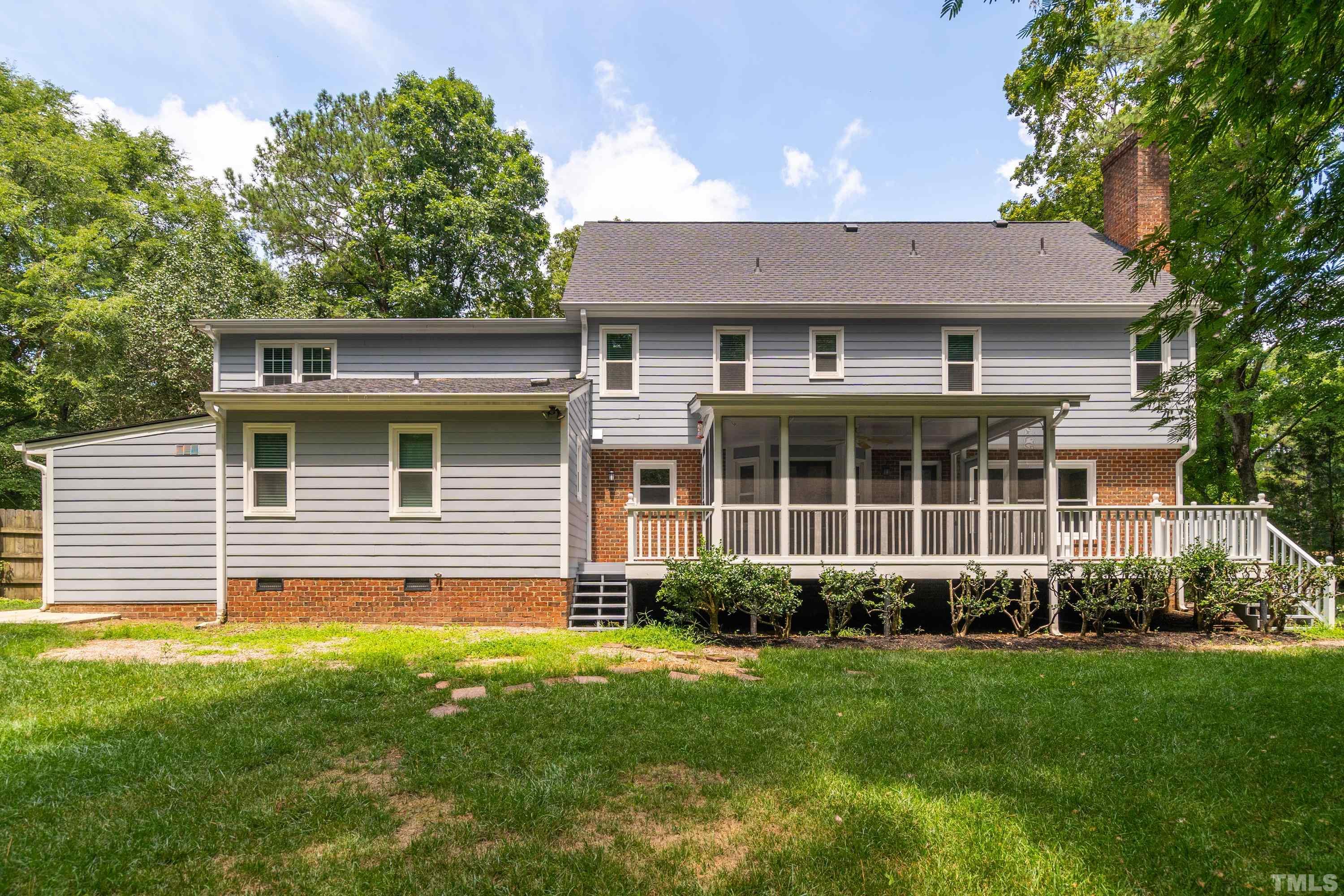 2013 Countrywood Road North Raleigh, NC 27615 - Photo 49 of 73 a view of a house with a yard potted plants and a large tree