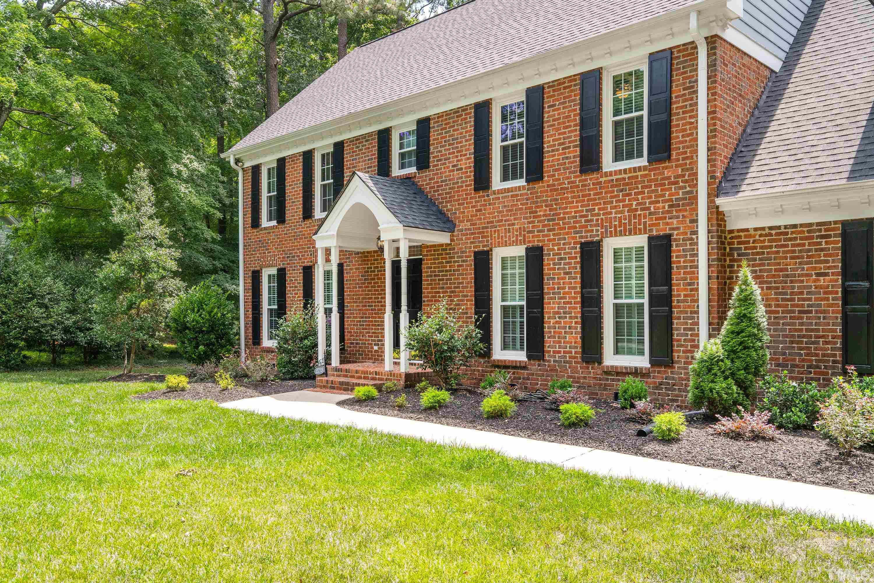 2013 Countrywood Road North Raleigh, NC 27615 - Photo 5 of 73 a front view of a house with yard and green space