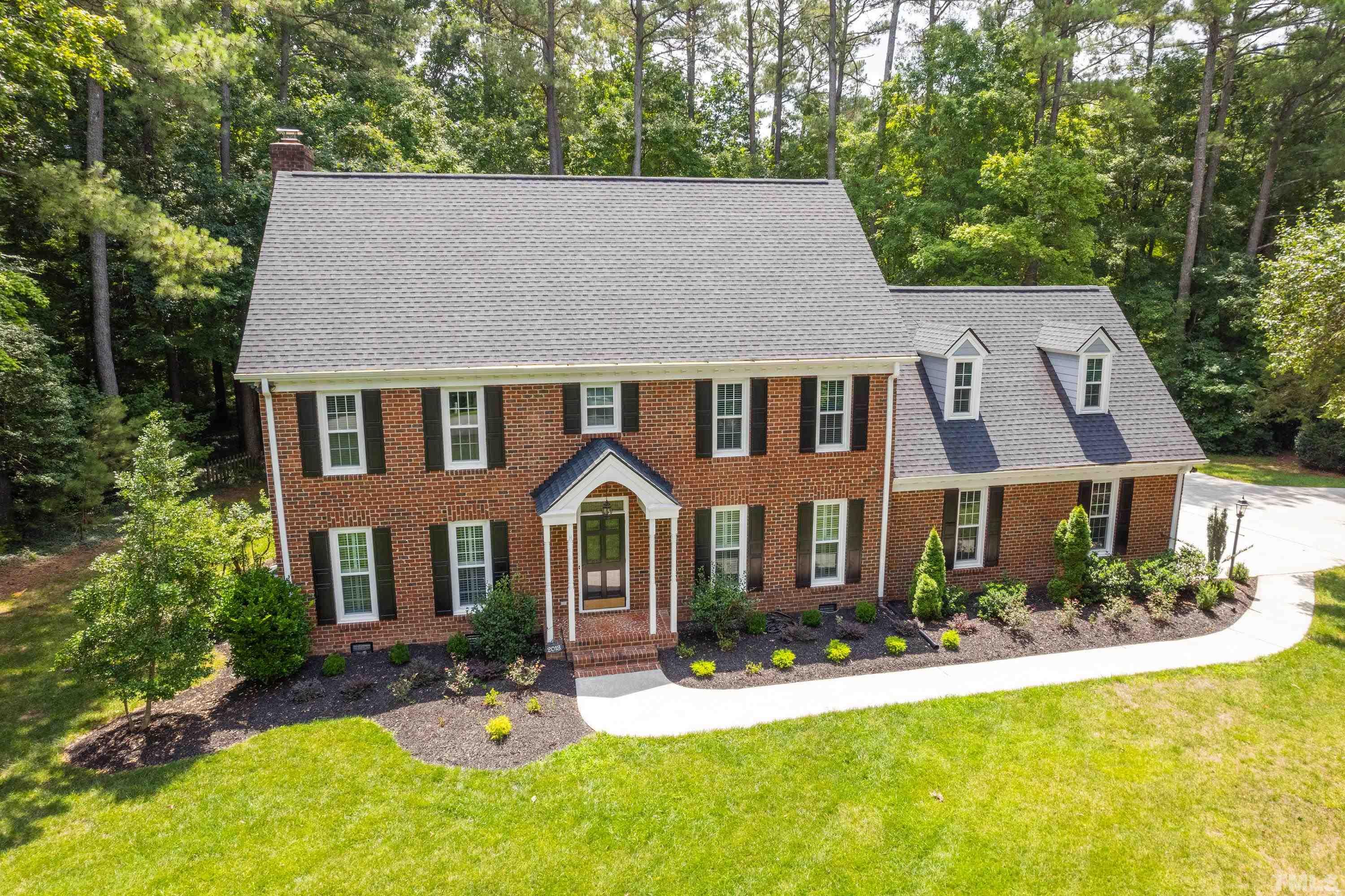 2013 Countrywood Road North Raleigh, NC 27615 - Photo 65 of 73 a front view of a house with yard and green space