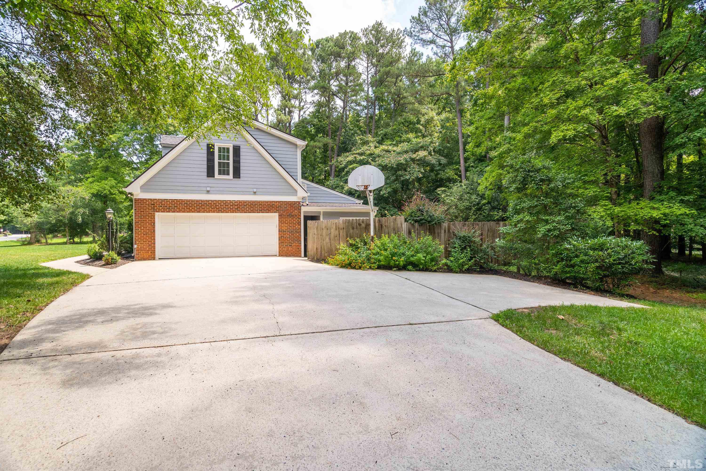 2013 Countrywood Road North Raleigh, NC 27615 - Photo 7 of 73 a front view of a house with a yard and garage