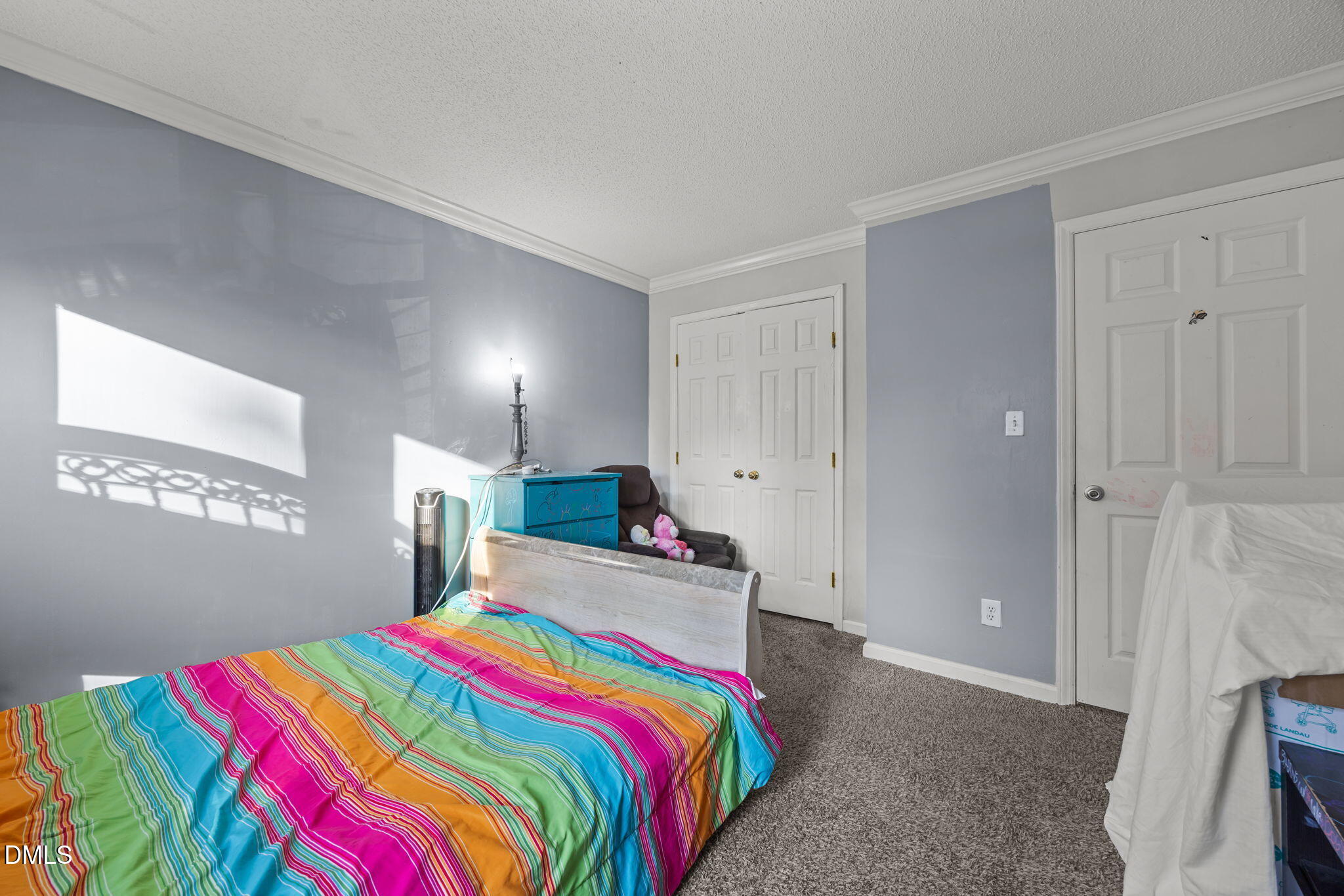 4700 Tolley Court Raleigh, NC 27616 - Photo 28 of 37 a bedroom with a bed and a chandelier