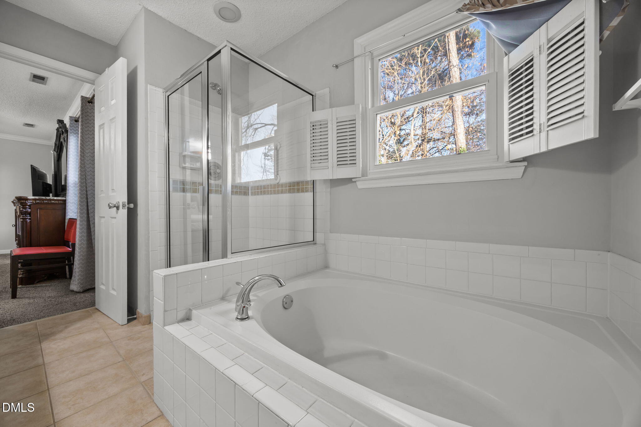 4700 Tolley Court Raleigh, NC 27616 - Photo 32 of 37 a bathroom with a bathtub and a shower