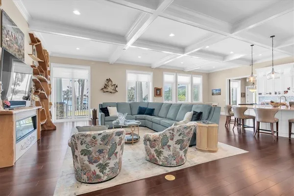 a kitchen with stainless steel appliances kitchen island granite countertop a table chairs and a refrigerator