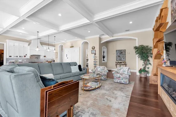 a kitchen with a dining table chairs wooden floor cabinets and stainless steel appliances