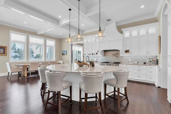 a dining room with furniture a chandelier and wooden floor