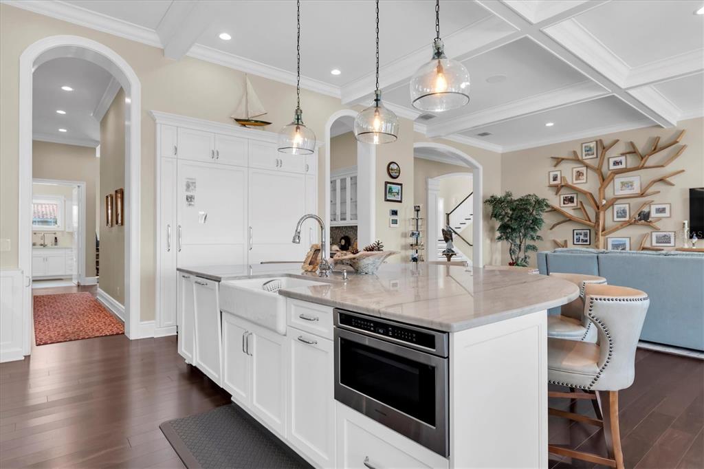 4650 Ridgeview Road Palm Harbor, FL 34684 - Photo 19 of 100 a kitchen with stainless steel appliances a stove center island a dining table and chairs