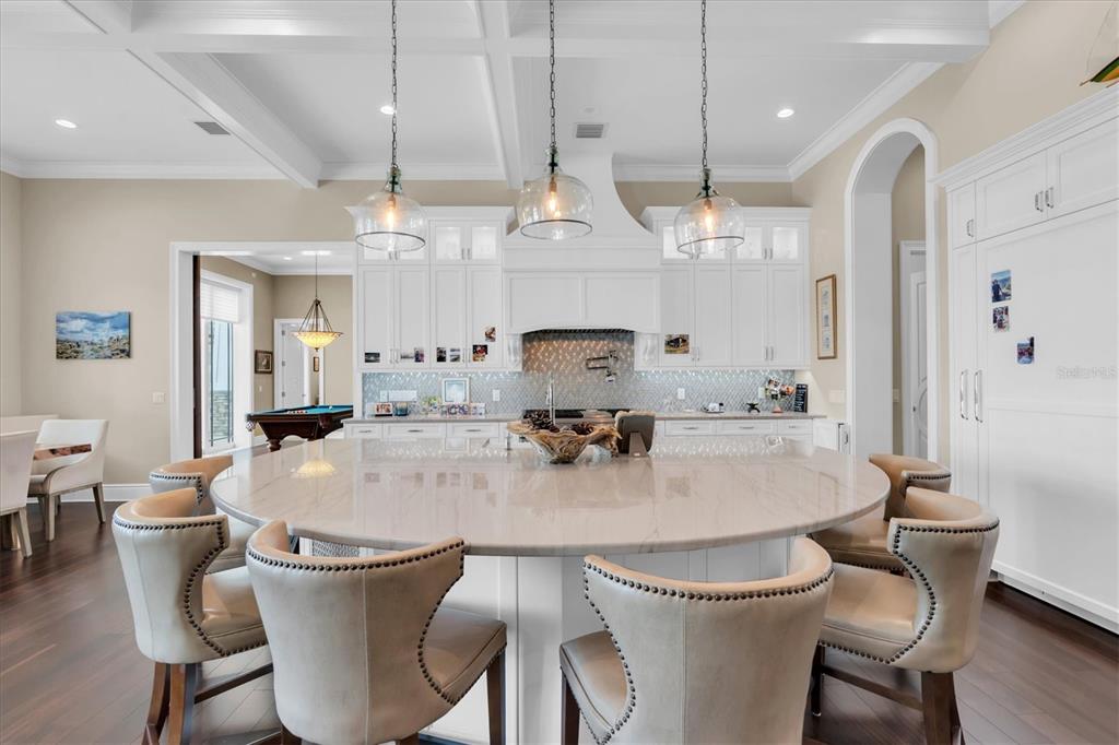 4650 Ridgeview Road Palm Harbor, FL 34684 - Photo 22 of 100 a dining room with wooden floor a chandelier a wooden table and chairs