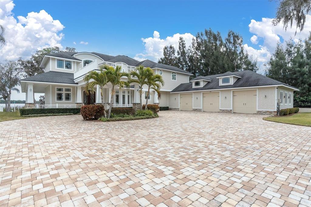 4650 Ridgeview Road Palm Harbor, FL 34684 - Photo 3 of 100 a view of a white house with a yard