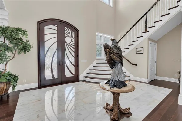 a living room with furniture a flat screen tv and a wall painting