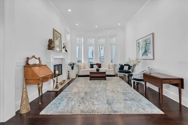 a living room with fireplace furniture and a wooden floor