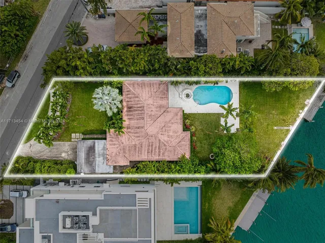 an aerial view of a house with a lake view
