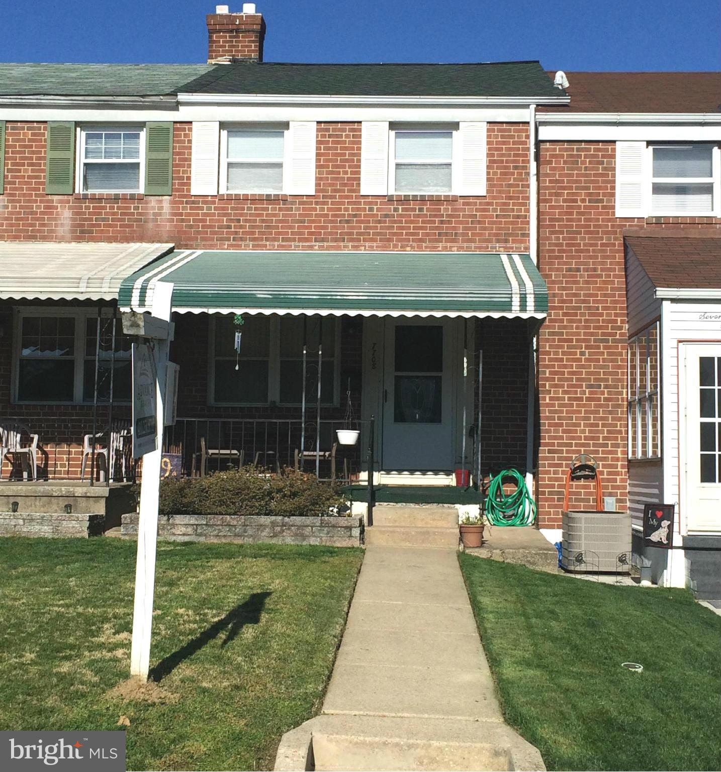 7708 Charlesmont Road Baltimore, MD 21222 - Photo 1 of 28 a front view of a house with a yard