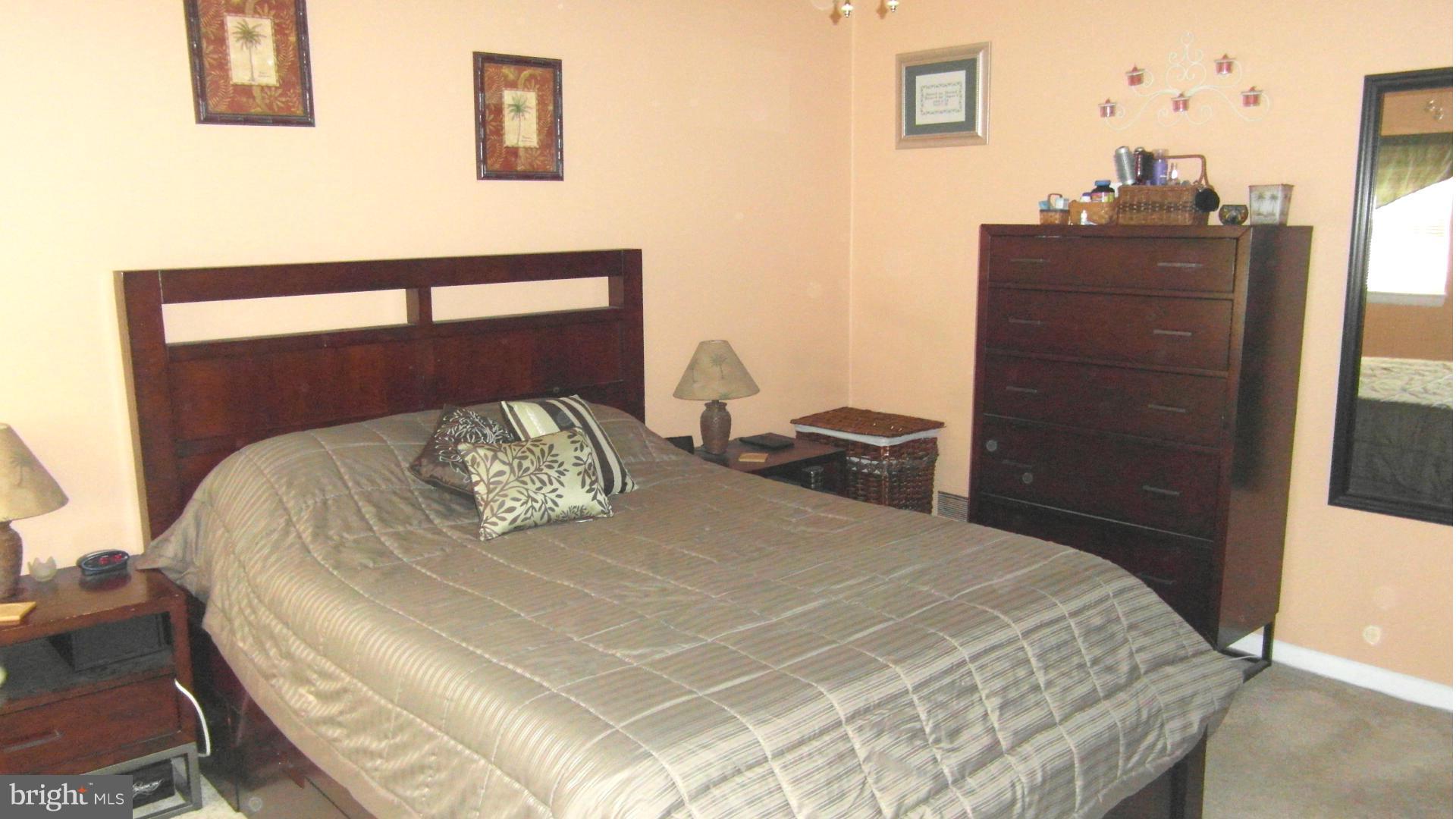 7708 Charlesmont Road Baltimore, MD 21222 - Photo 11 of 28 a bedroom with a bed and dresser