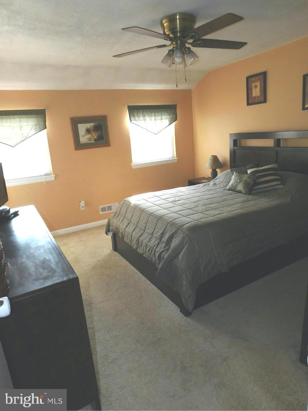 7708 Charlesmont Road Baltimore, MD 21222 - Photo 13 of 28 a bedroom with a bed and a chandelier