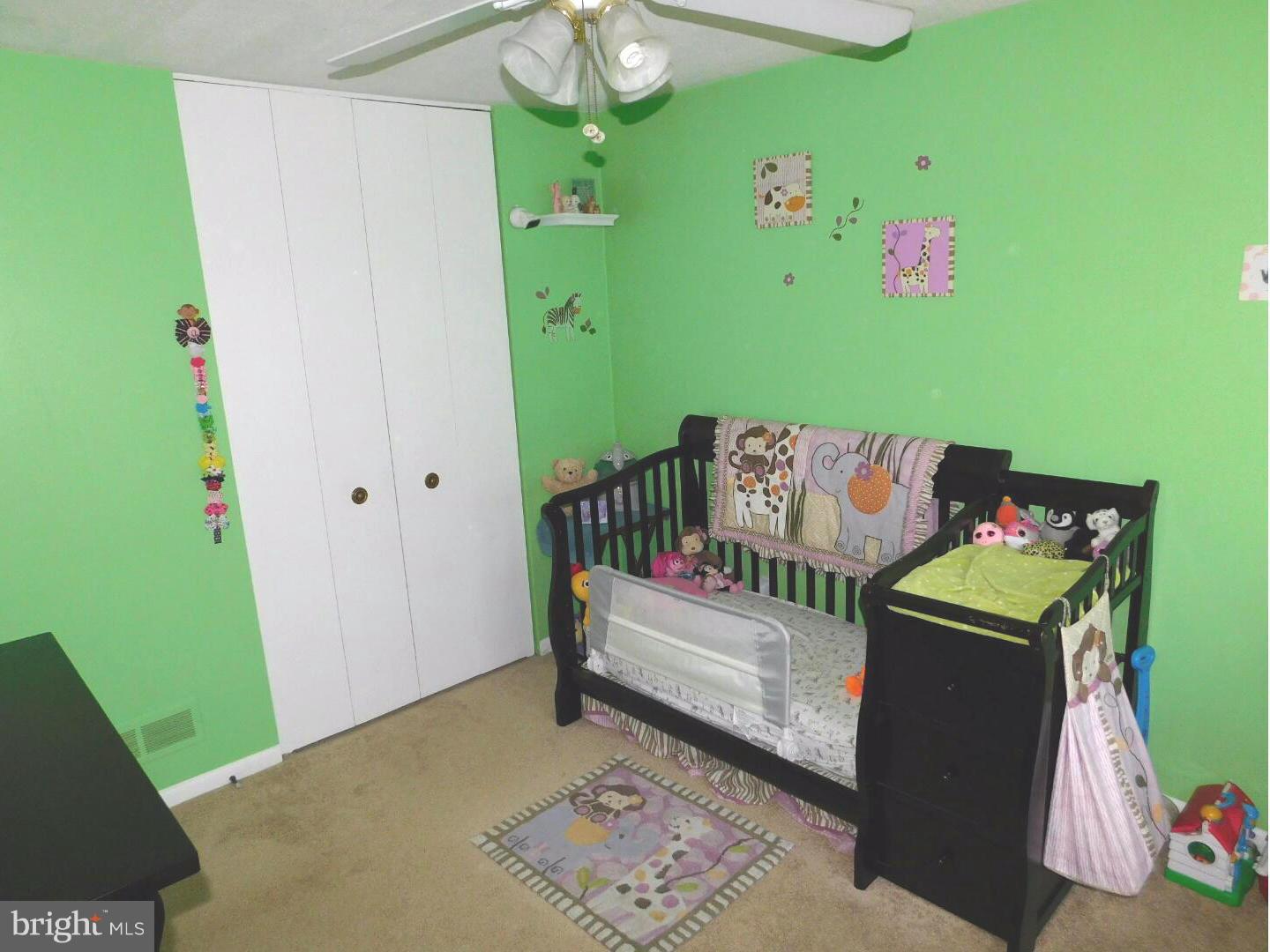 7708 Charlesmont Road Baltimore, MD 21222 - Photo 17 of 28 a bedroom with a bed and a window