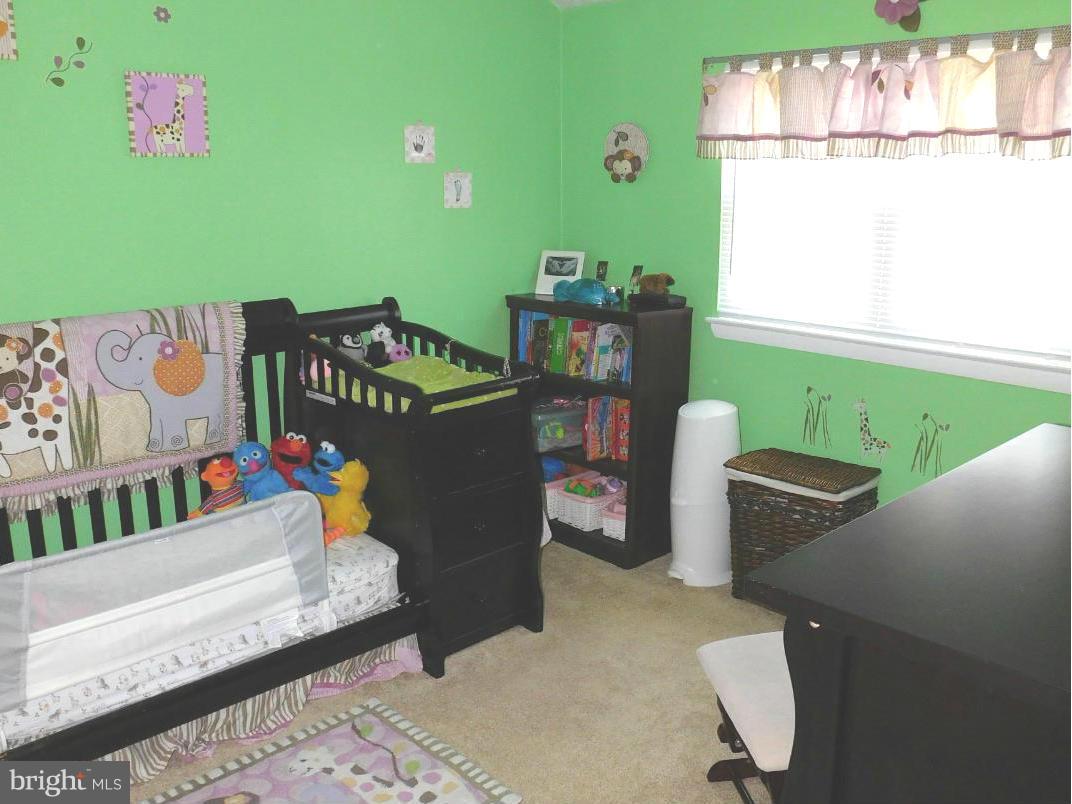 7708 Charlesmont Road Baltimore, MD 21222 - Photo 18 of 28 a room with furniture and a window