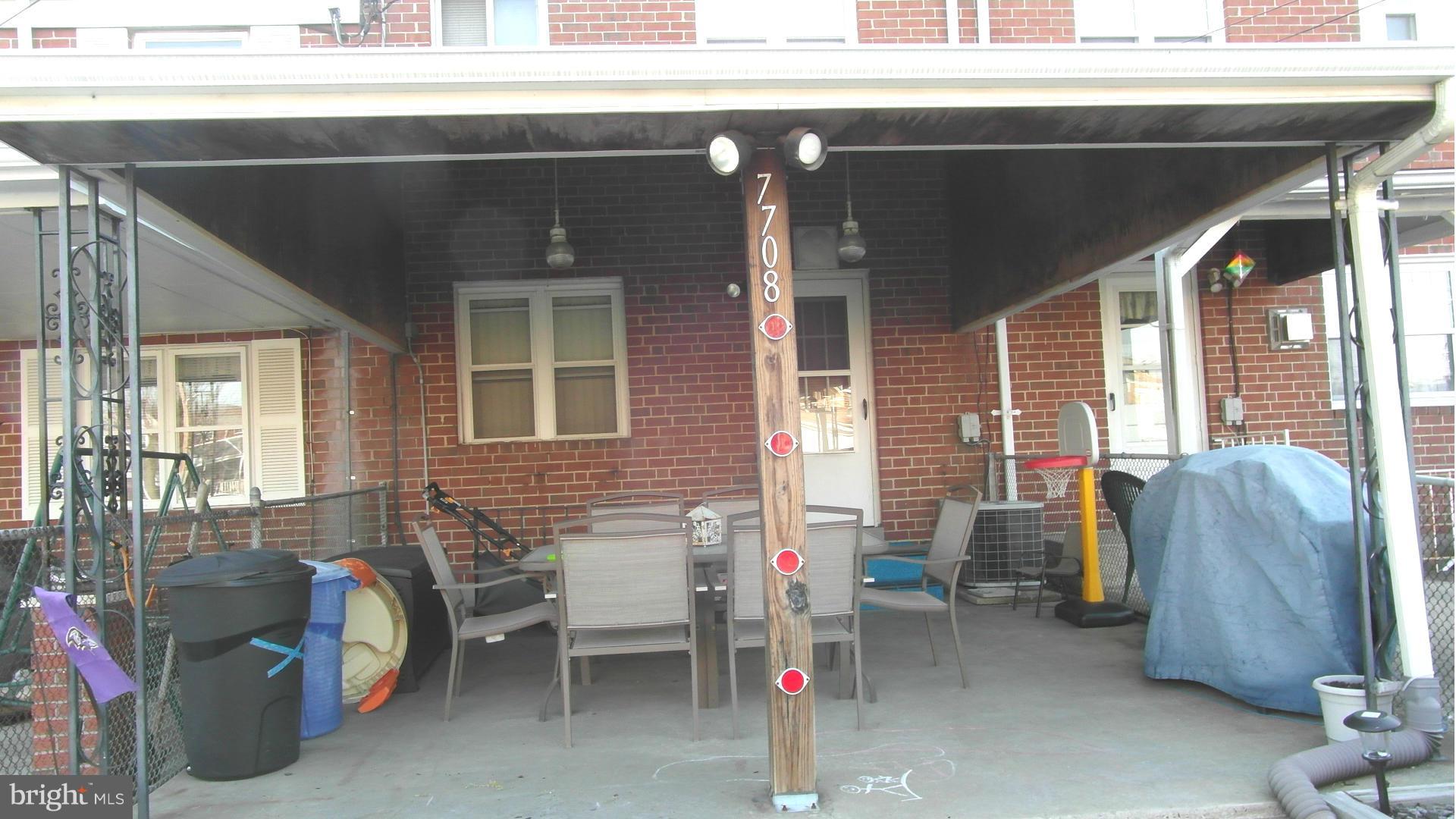 7708 Charlesmont Road Baltimore, MD 21222 - Photo 28 of 28 a backyard of a house with outdoor seating